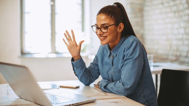 A women giving an interview on a laptop