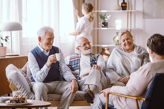Senior citizens talking in a old age house