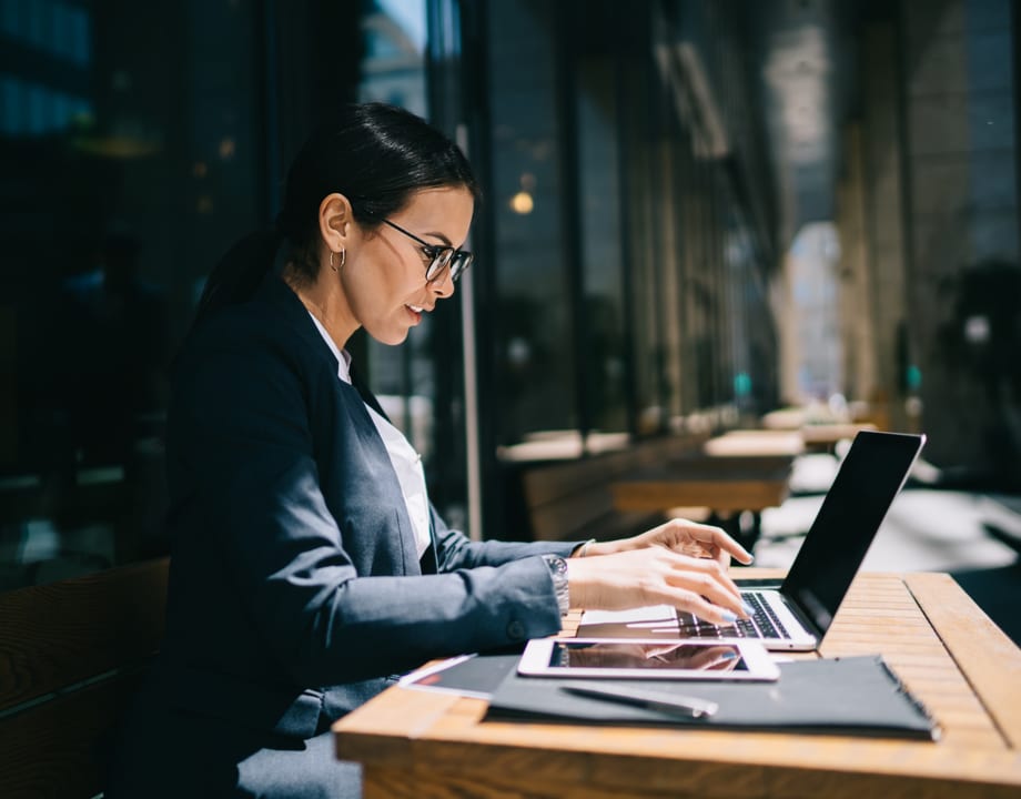 A lady working on a laptop in dark environment
