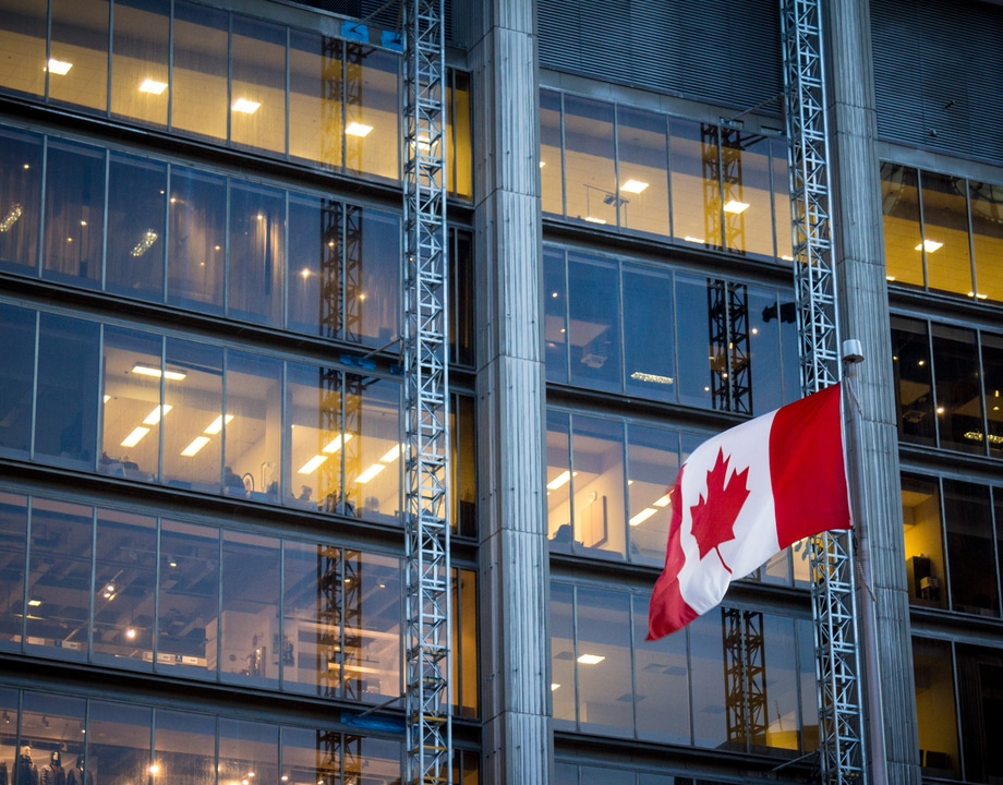 Canadian flag in front of building