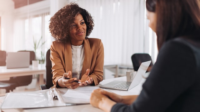 A lady asking interview questions to the candidate
