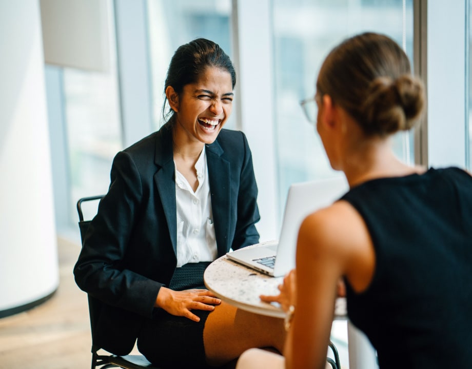 Happy women laughing in office
