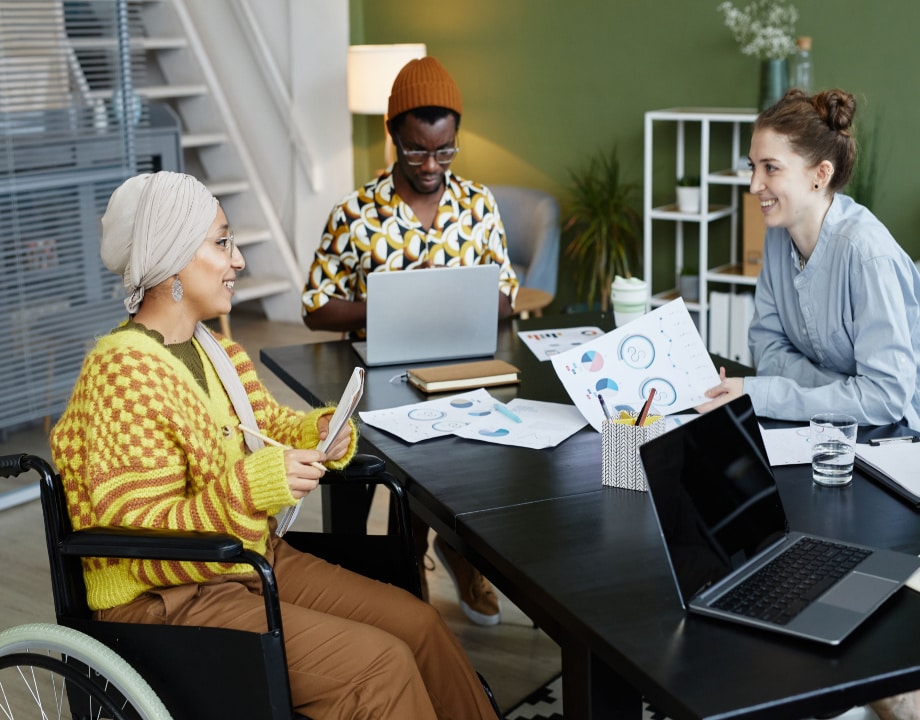 Two women and one man working in an office