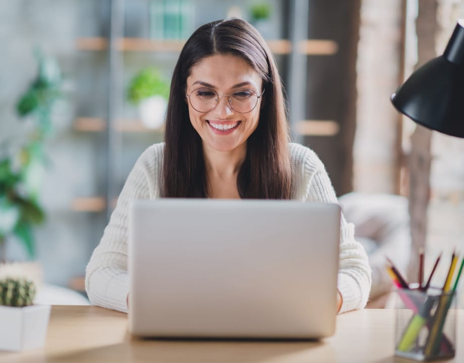A happy women working on a laptop