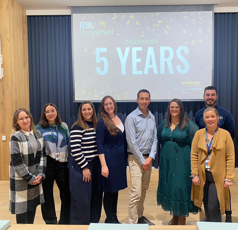 People celebrating 5 years while posing for a photo