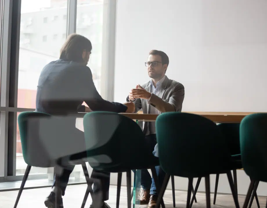 Two men talking in an office meeting room